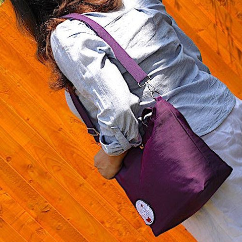 woman in garden with purple bag