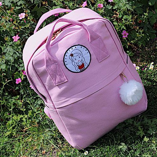 Pink womens backpack in garden